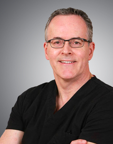 Photo of Dr. Normand Miller in black scrubs
